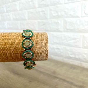 Elastic/stretch teal and gold peacock pattern bracelet.